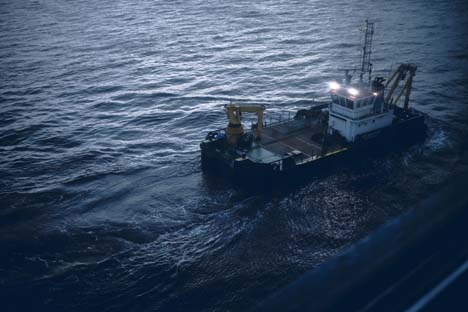 Tug Boat in water at night